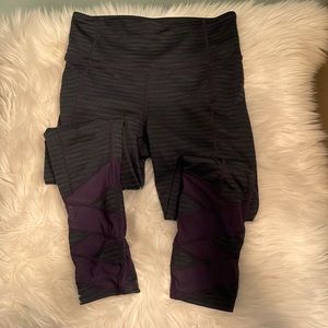 Athleta capri black/blue leggings with sheer design at bottom. Size xs.